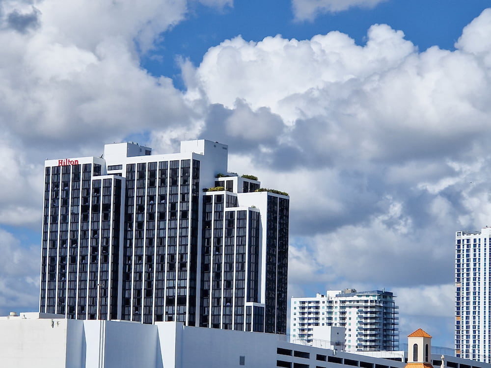 Exterior of Hilton Miami Downtown hotel, popular pre-cruise stay with shuttle