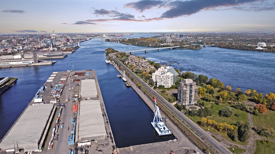 Aerial view of the Montreal waterfront and port, the Saint Lawrence River, and the city skyline.