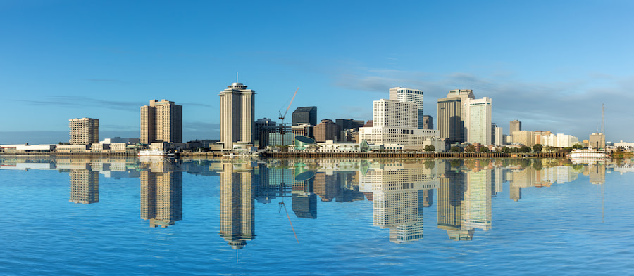 New Orleans skyline reflecting symmetrically on the calm Mississippi River
