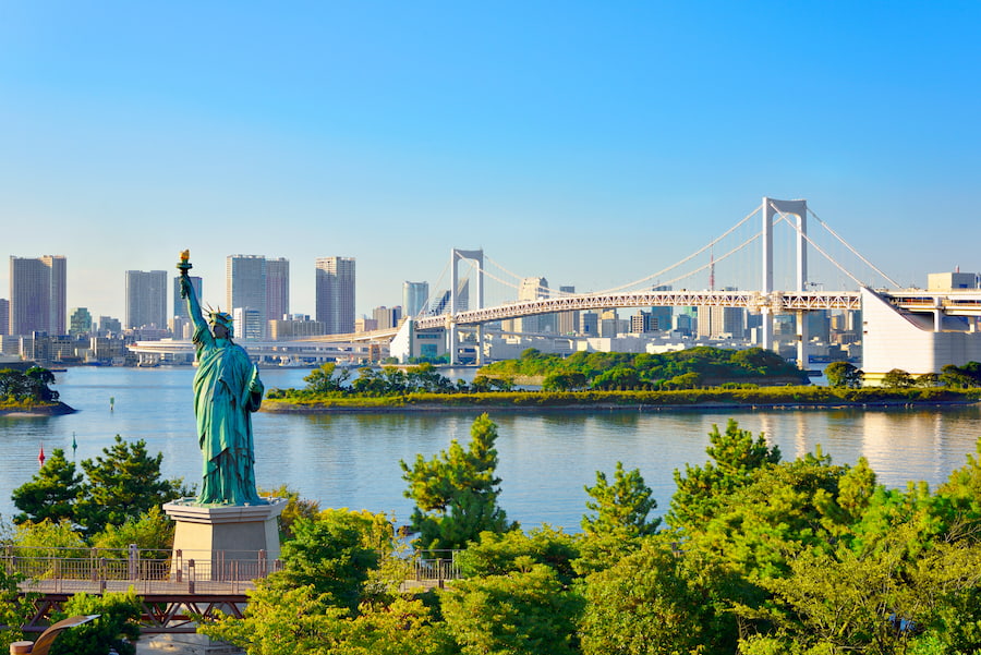The Statue of Liberty replica and Rainbow Bridge over Tokyo Bay in Odaiba, Japan
